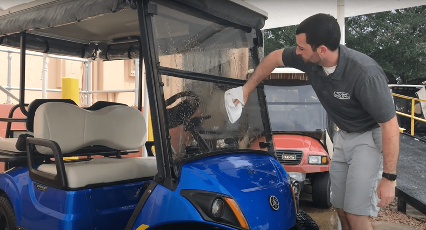 Man Cleaning Golf Cart