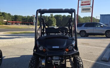 Black EZGO golf cart in parking lot.